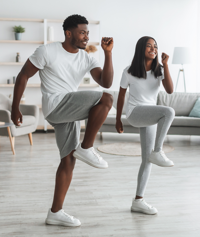 Father dancing joyfully with his child at home, showing fun and active family movement