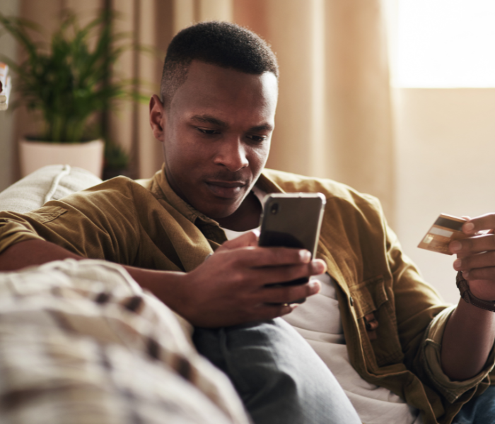 Illustration of mobile banking and digital payment use with warning symbols representing phishing, SIM-swap fraud, and online scam risks in South Africa