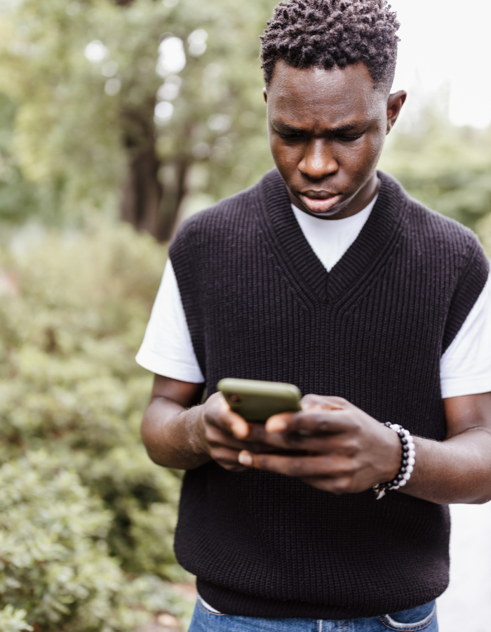 A symbolic image showing a vulnerable teenager using an AI chatbot alone on a phone in a dark environment, representing risks of AI in mental health crises.