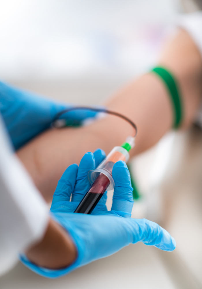 Healthcare professional collecting blood from a donor as part of the stem cell donation process.