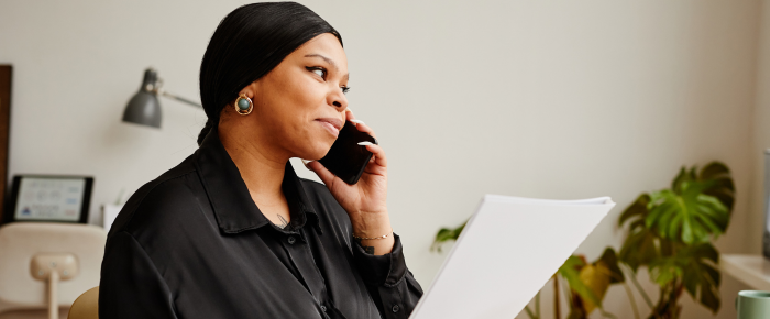 Woman speaking with a financial advisor about retirement planning and long-term financial goals.