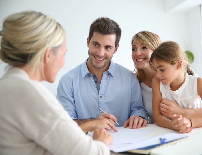 Family sitting with financial advisor discussing estate planning and Will arrangements in an office meeting