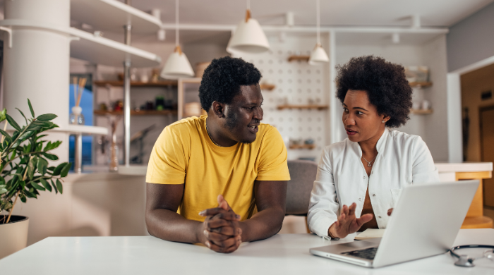 Person reviewing medical aid and gap cover documents with financial advisor to plan healthcare protection in South Africa