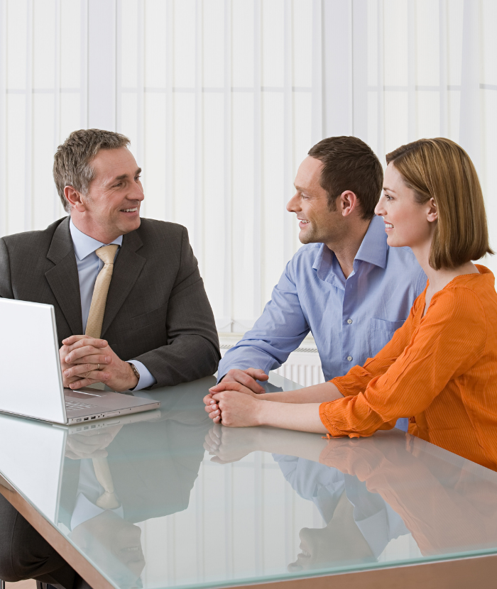 Couple meeting with a financial advisor reviewing and updating their Will and estate planning documents